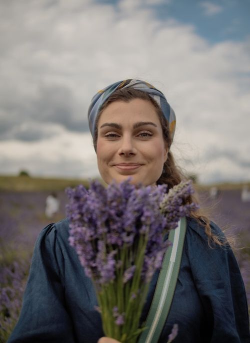 Aude is holding a bouquet of lavender.